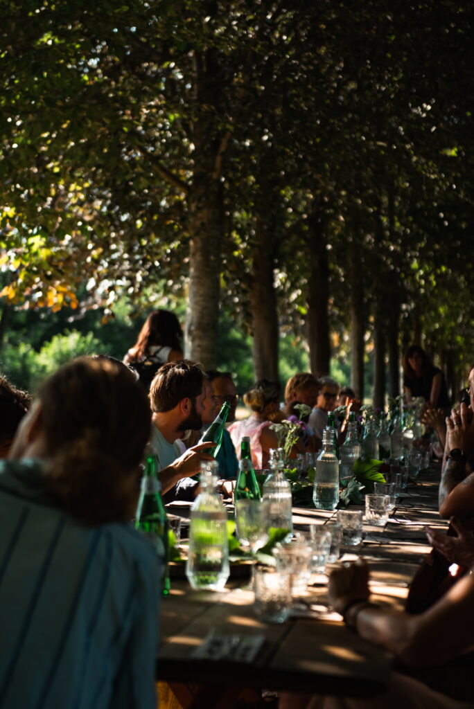 Long forest table dining under trees during SYLVA at Yūgen Forest